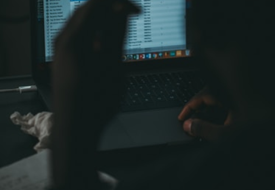 Silhouette of man looking at screen